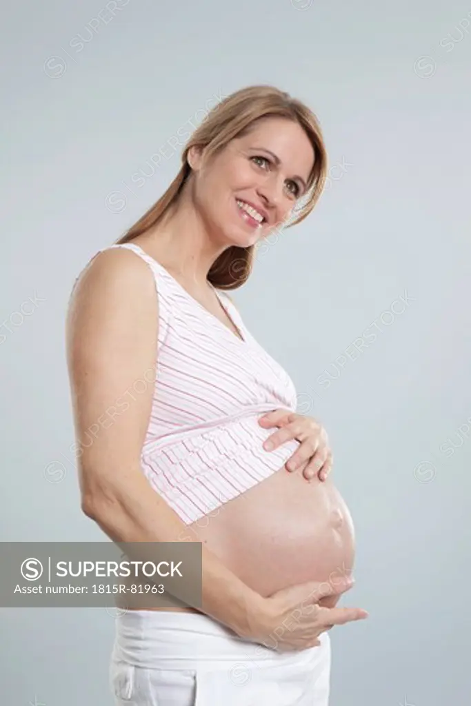 Pregnant mid adult woman, smiling