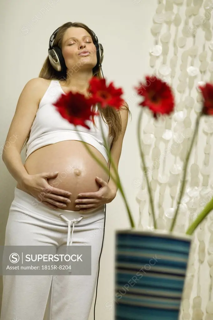 Pregnant woman wearing headphones