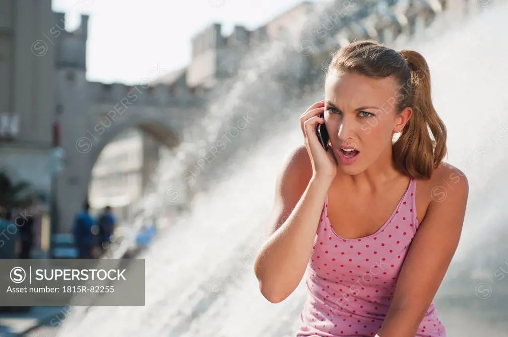 Germany, Munich, Karlsplatz, Young woman on the phone