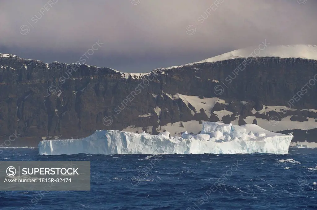 Antarctic, Antarctic Peninsula, View of iceberg in sea with mountain