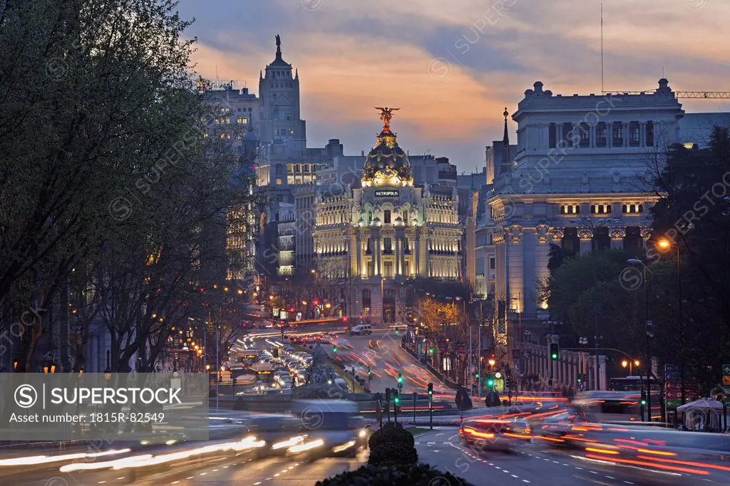 Madrid, View of Calle de Alcala and Plaza de Cibeles, Edificio Metropolis blurred traffic at dusk