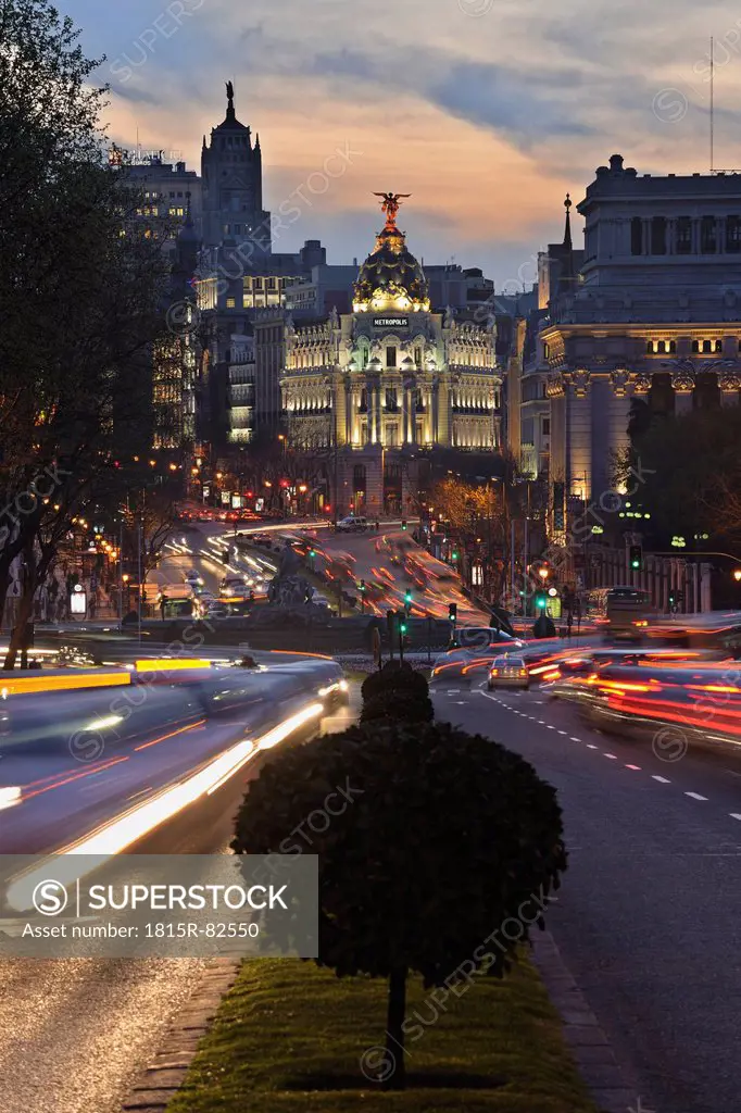 Madrid, View of Calle de Alcala and Plaza de Cibeles, Edificio Metropolis blurred traffic at dusk