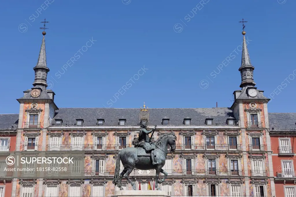 Spain, Madrid, Statue of Felipe III with Casa De La Panaderia at Plaza Mayor