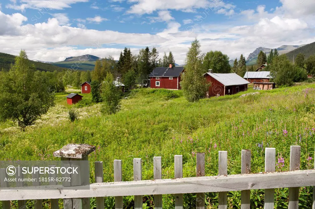 Sweden, Lapland, Fence and cottages in the community of Kvikkjokk
