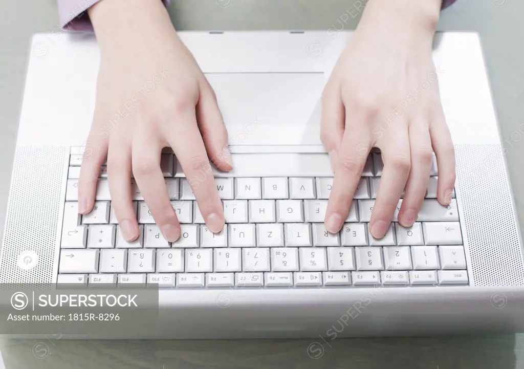 Woman typing on computer, elevated view