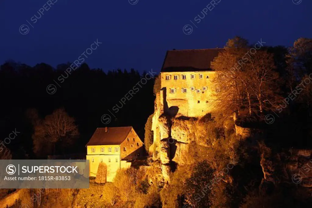 Germany, Bavaria, Franconia, Upper Franconia, Franconian Switzerland, Pottenstein, View of castle on top of mountain at night