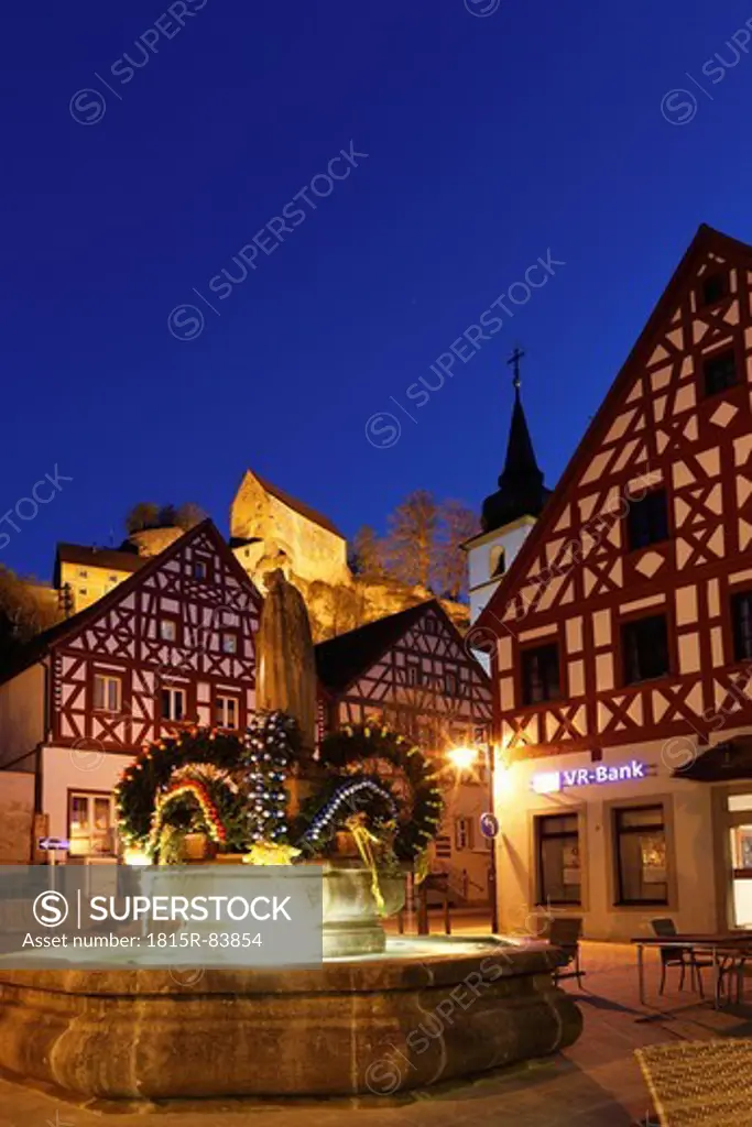 Germany, Bavaria, Franconia, Upper Franconia, Franconian Switzerland, Pottenstein, Osterbrunnen, View of town with easter decoration on fountain at night
