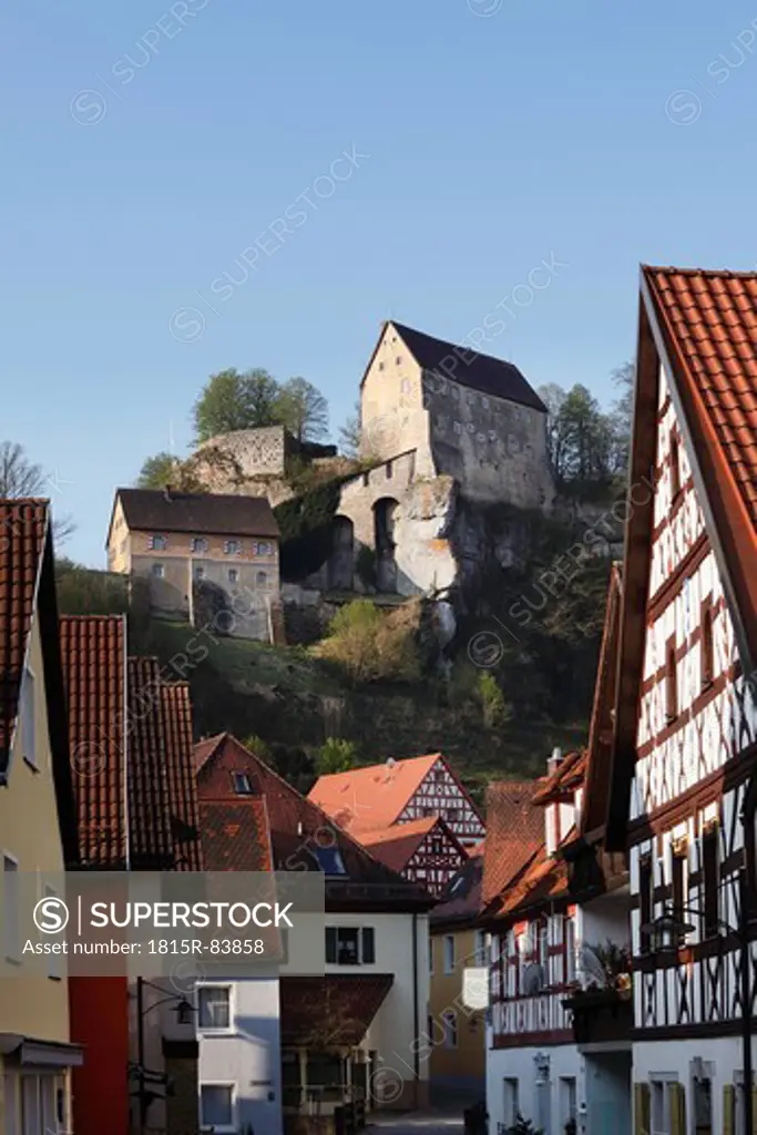 Germany, Bavaria, Franconia, Upper Franconia, Franconian Switzerland, Pottenstein, View of castle on top of mountain with town in foreground