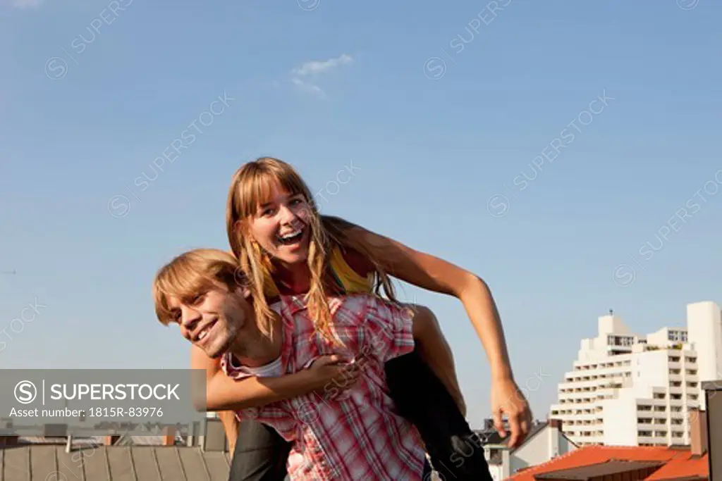 Germany, Bavaria, Munich, Young couple enjoying on rooftop