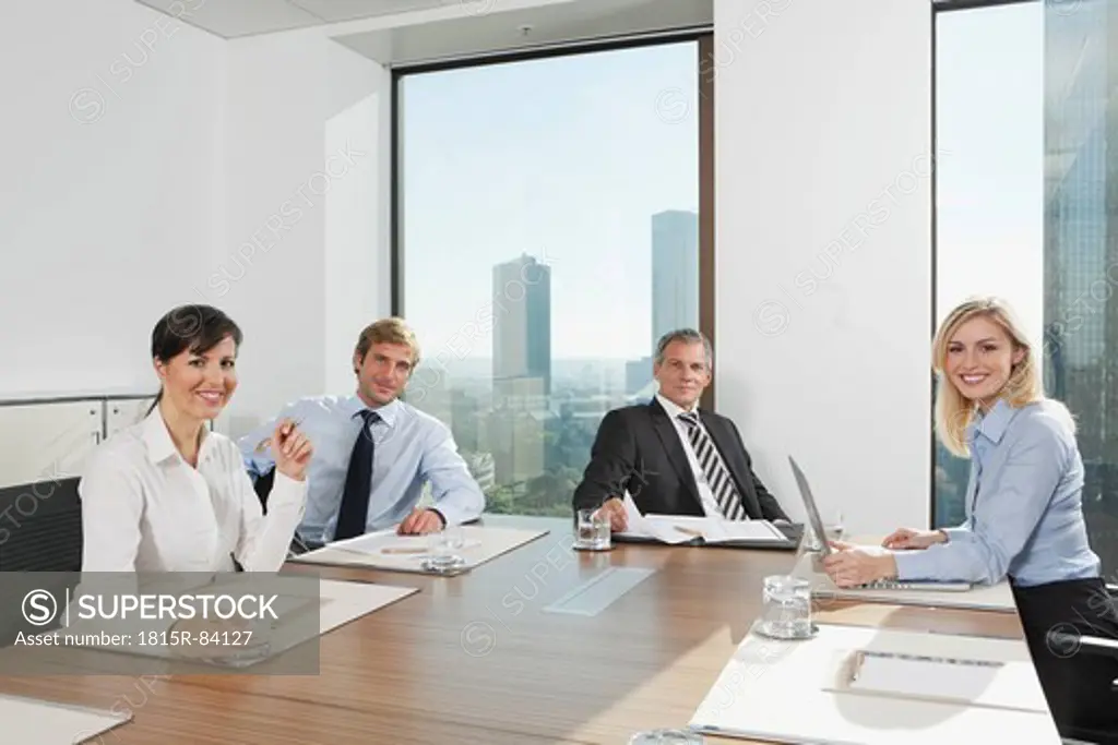 Germany, Frankfurt, Business people in conference room, smiling, portrait