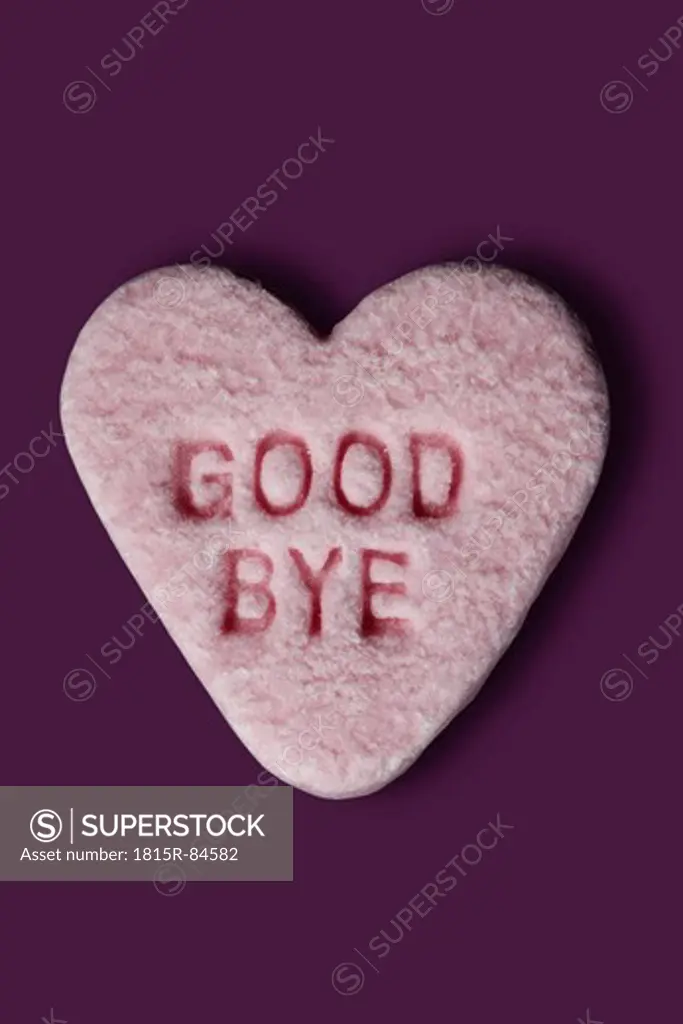 Heart shaped sweets with text against purple background