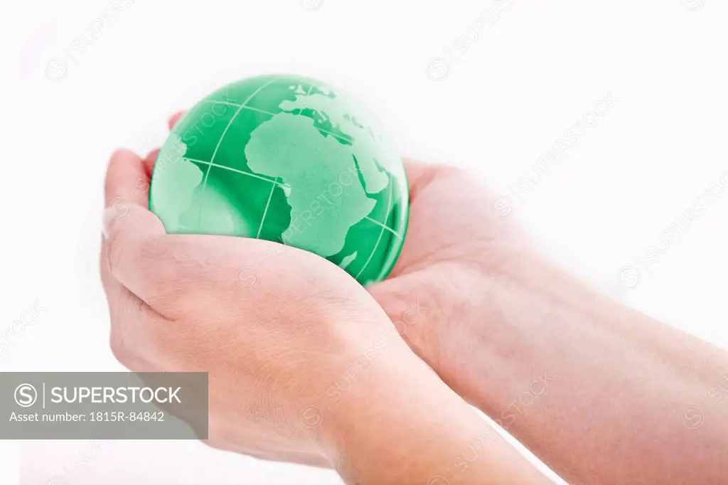 Human hand holding glass globe, close_up