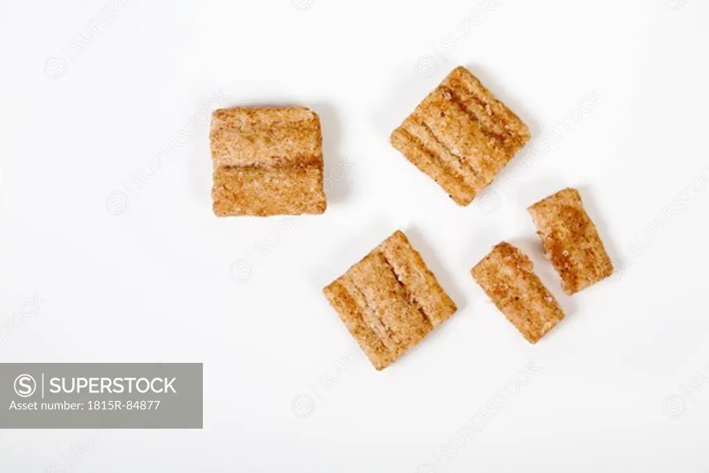 Close up of cinnamon chips on white background