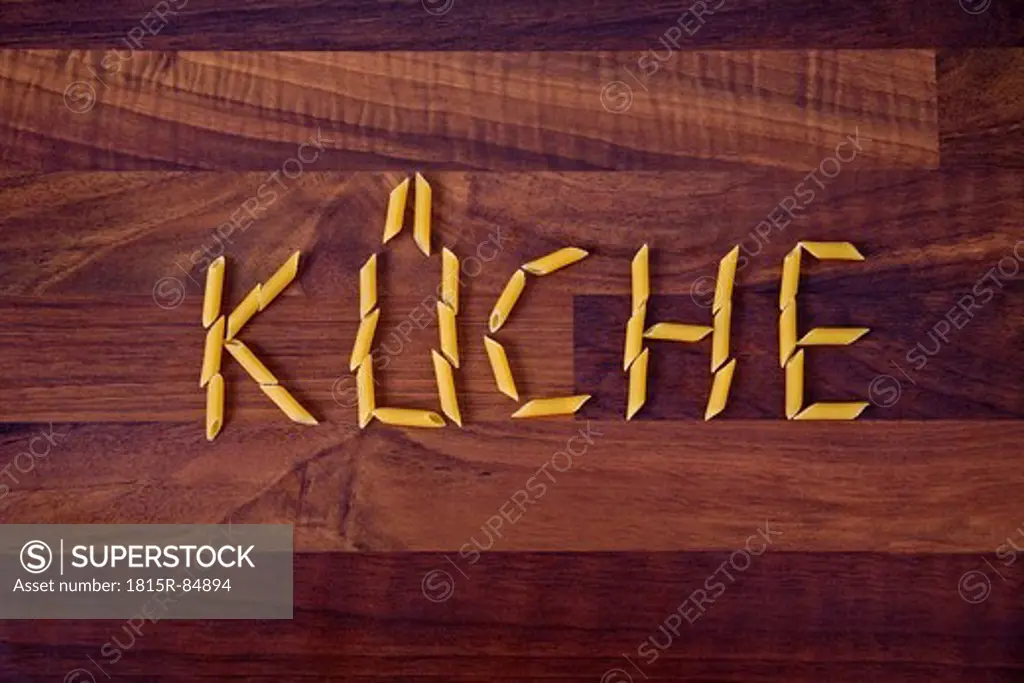Close up of word kitchen written with penne on wooden background