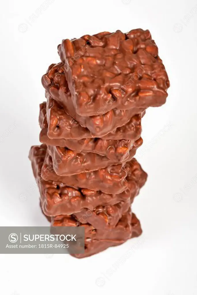 Stack of puffed rice coated with chocolate on white background
