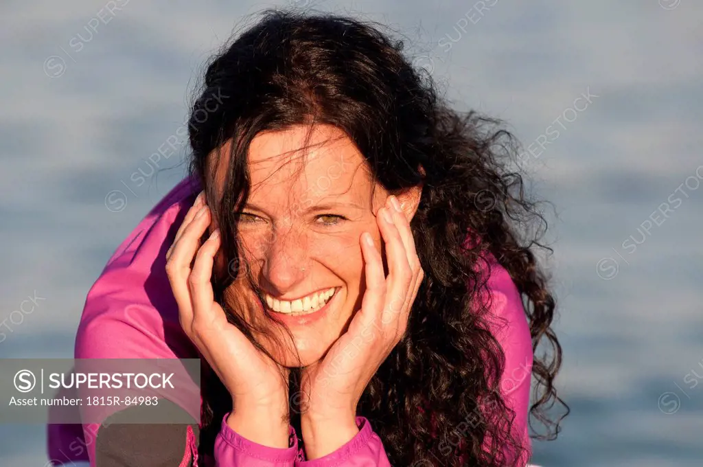 Mid adult woman on jetty, smiling, portrait