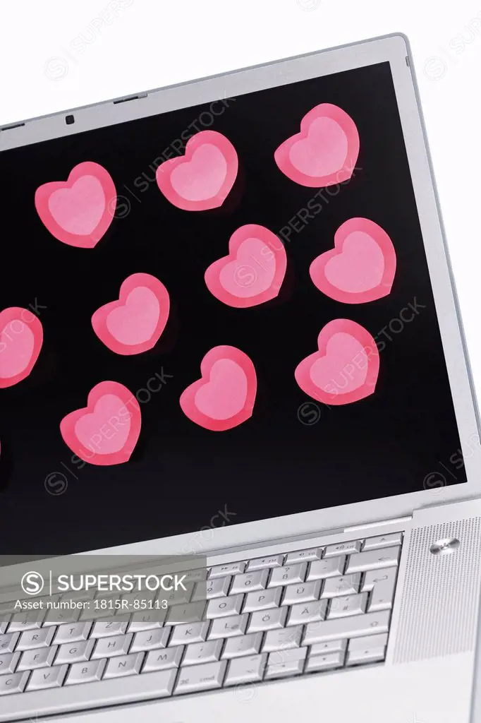 Heart shape stickers on laptop, close up