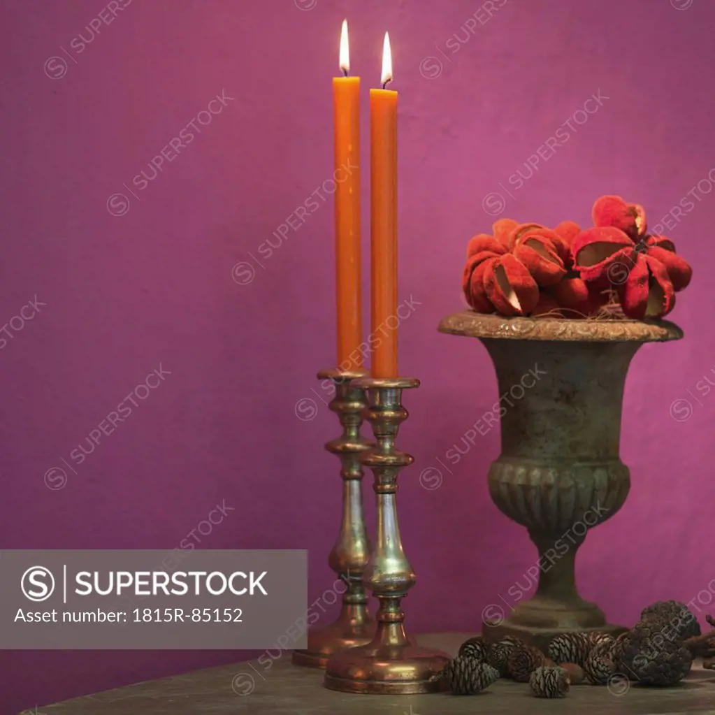 Candles with pine cones and vase