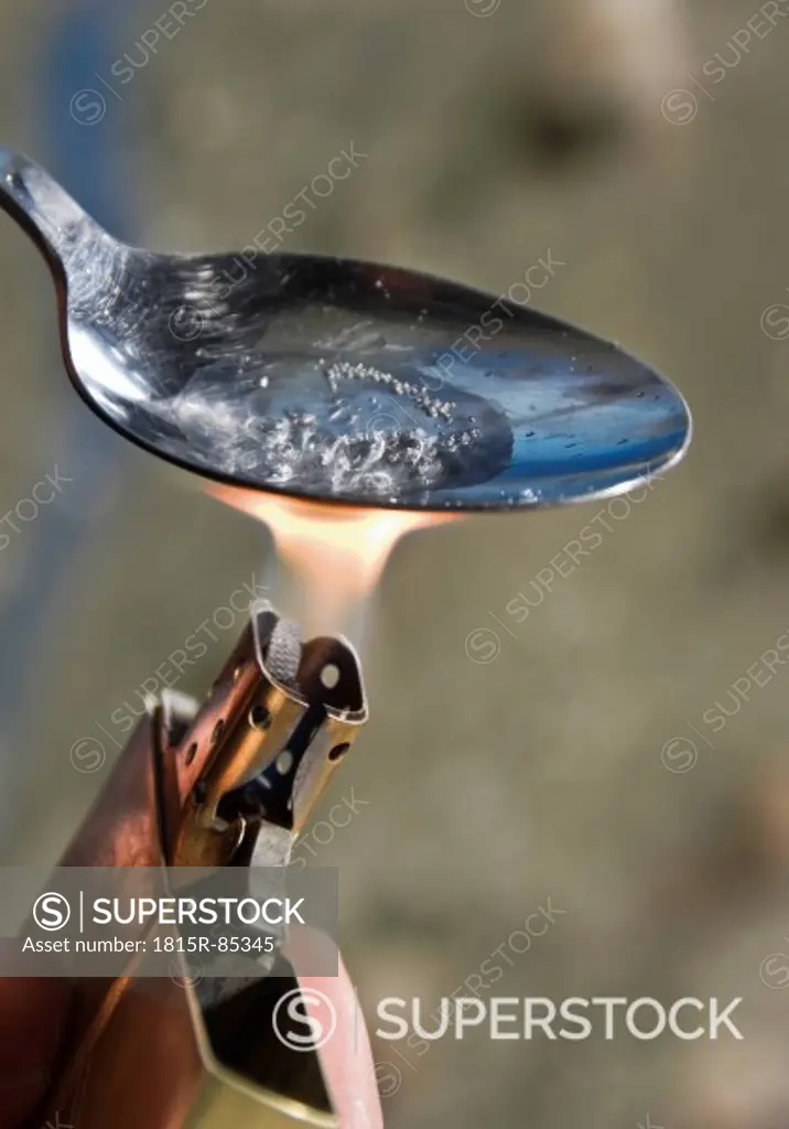 Heroin being heated with lighter, close up
