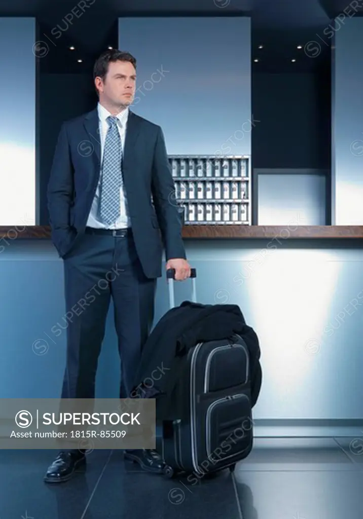 Germany, Ingolstadt, Business man with luggage waiting in lobby