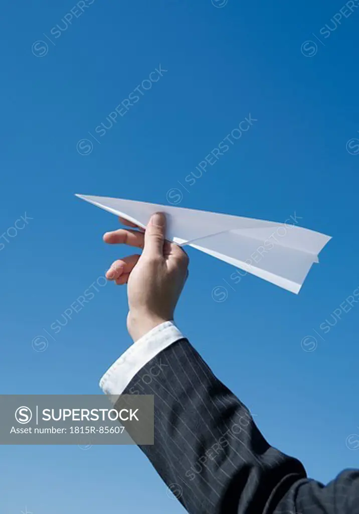Germany, Human hand with paper plane, close up