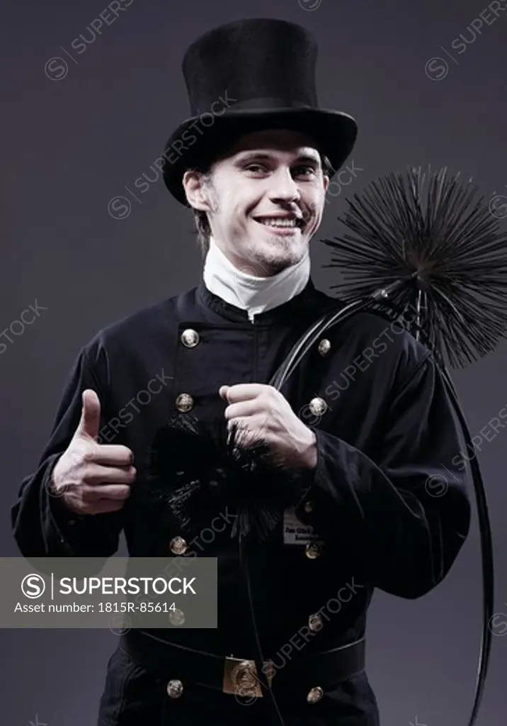 Germany, Chimney sweep showing thumbs up, portrait, smiling