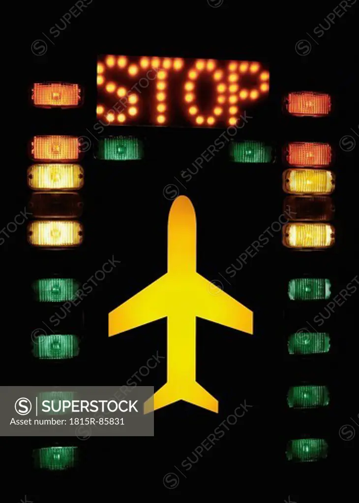 Germany, Lights with aircraft and stop sign on tower in airport
