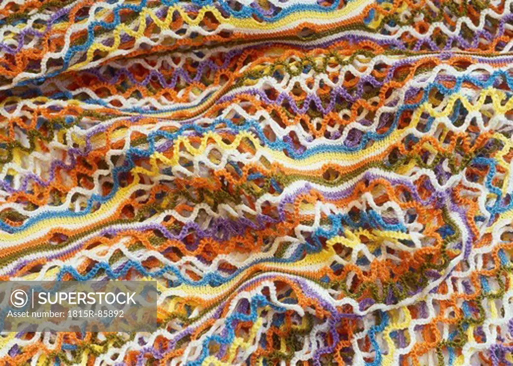 Background of colourful crochet fabric, close up
