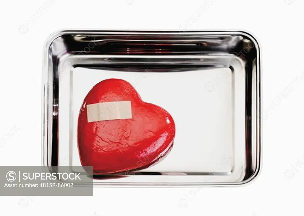 Heart with bandage in tray