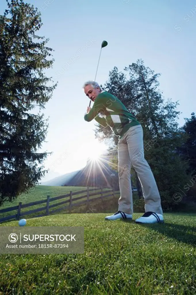 Italy, Kastelruth, Mature man playing golf on golf course