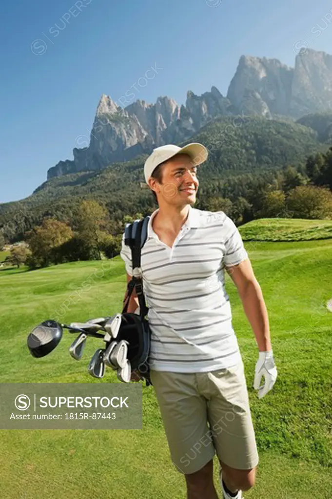 Italy, Kastelruth, Mid adult man walking on golf course
