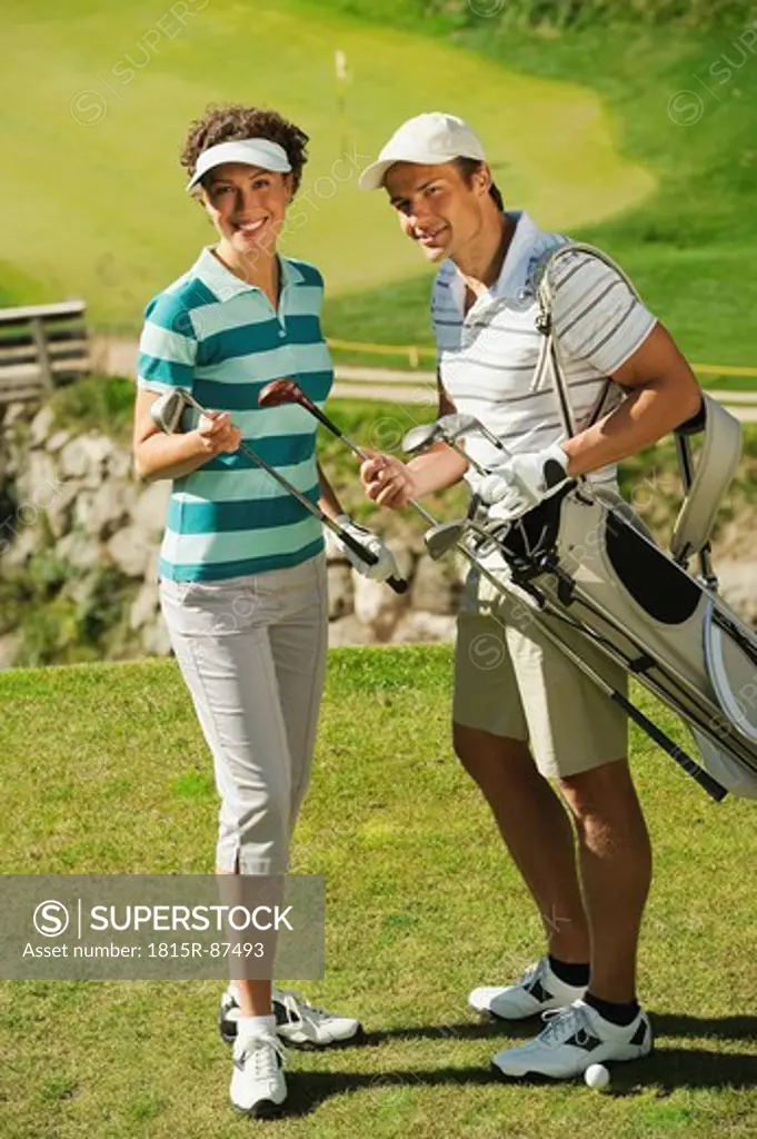 Italy, Kastelruth, Golfers on golf course, smiling, portrait