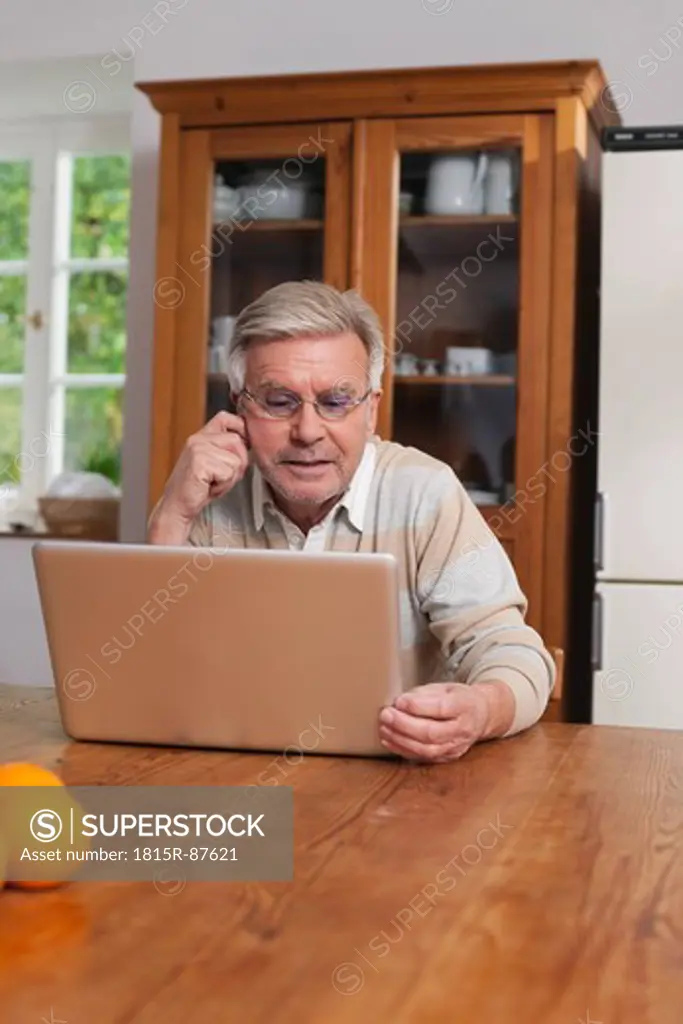 Germany, Kratzeburg, Senior man using laptop