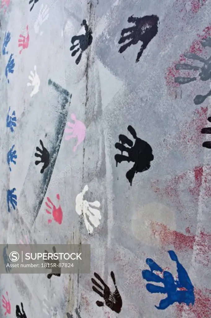 Germany, Berlin, Variety of handprints on berlin wall