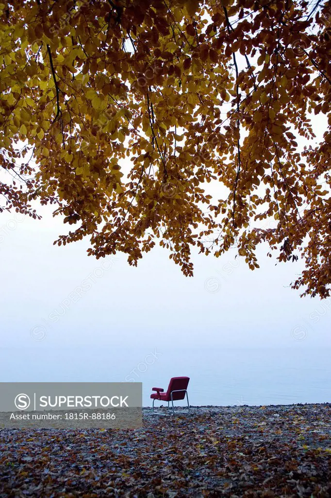 Austria, Salzkammergut, Mondsee, Outdoors chair by foggy lake