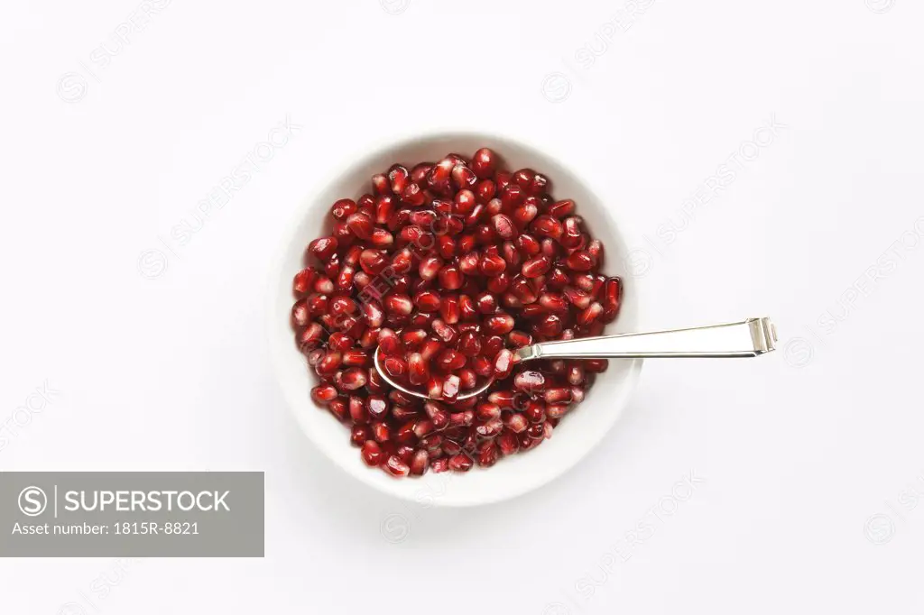 Pomegranate seeds in bowl, elevated view