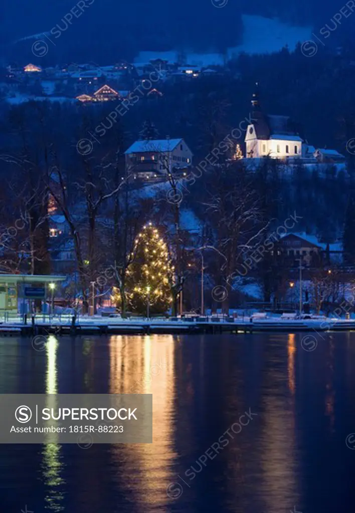 Austria, Salzkammergut, Mondsee, View of hilfbergkirche church with christmas tree by lake