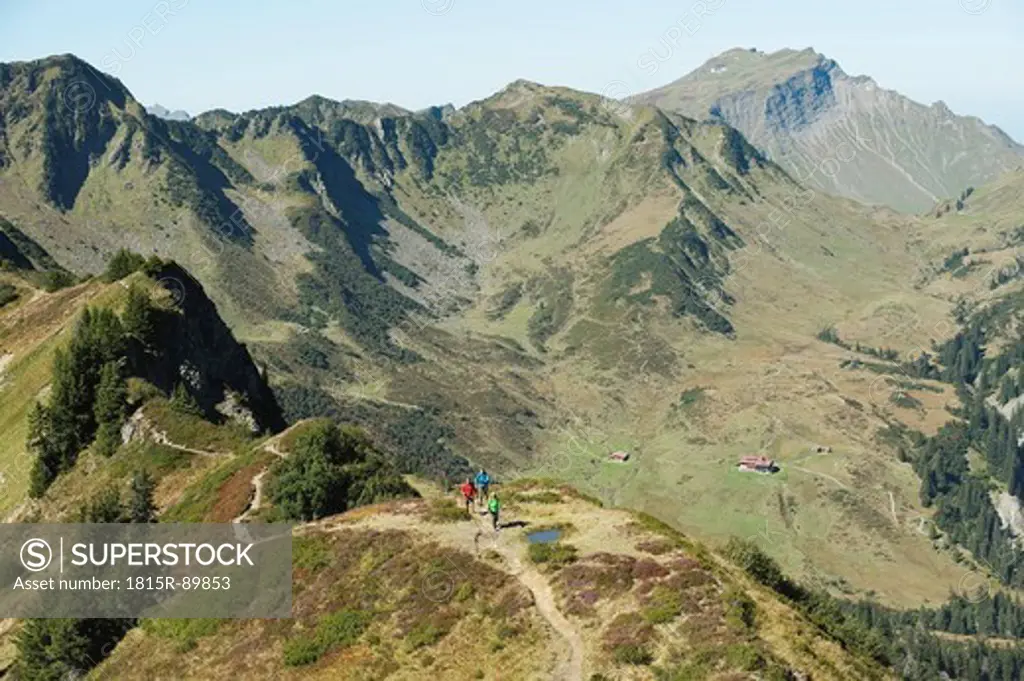 Austria, Kleinwalsertal, Group of people hiking on mountain trail