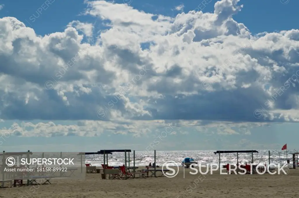 Italy, Forte dei Marmi, View of sandy beach with blue sky and white dense clouds