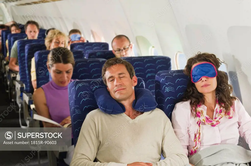 Germany, Munich, Bavaria, Passengers sleeping in economy class airliner