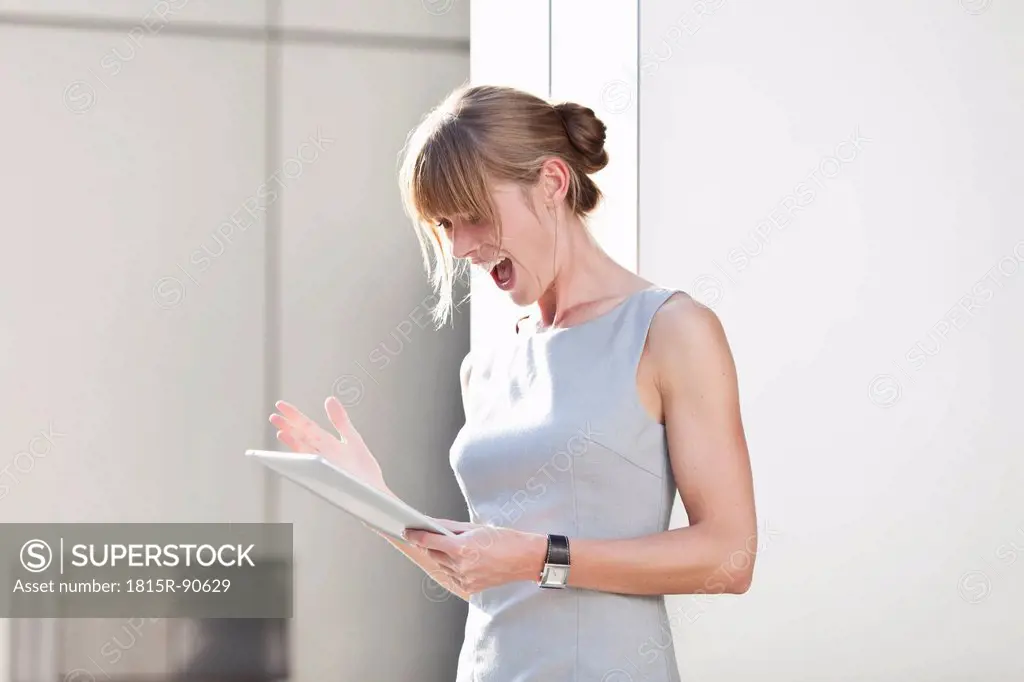 Germany, Bavaria, Munich, Young businesswoman with digital tablet