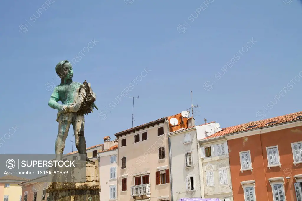 Croatia, Istria, Rovinj, View of statue in front of buildings