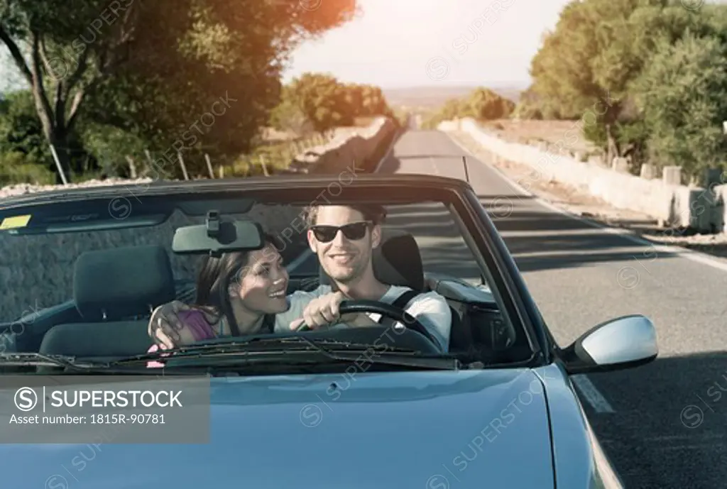 Spain, Majorca, Young couple travelling in cabriolet car