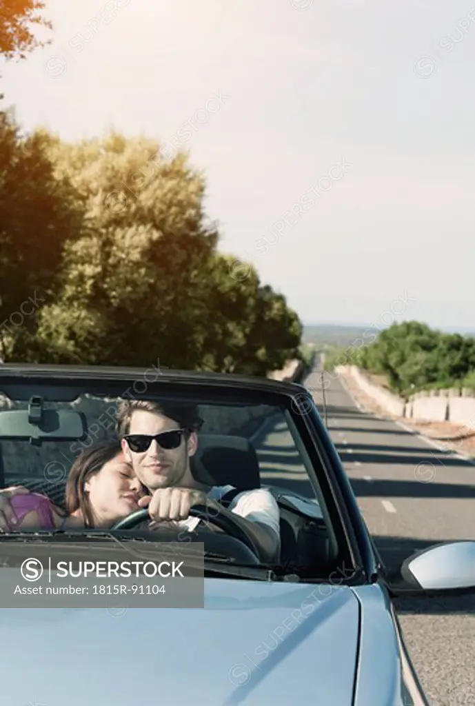 Spain, Majorca, Young couple travelling in cabriolet car