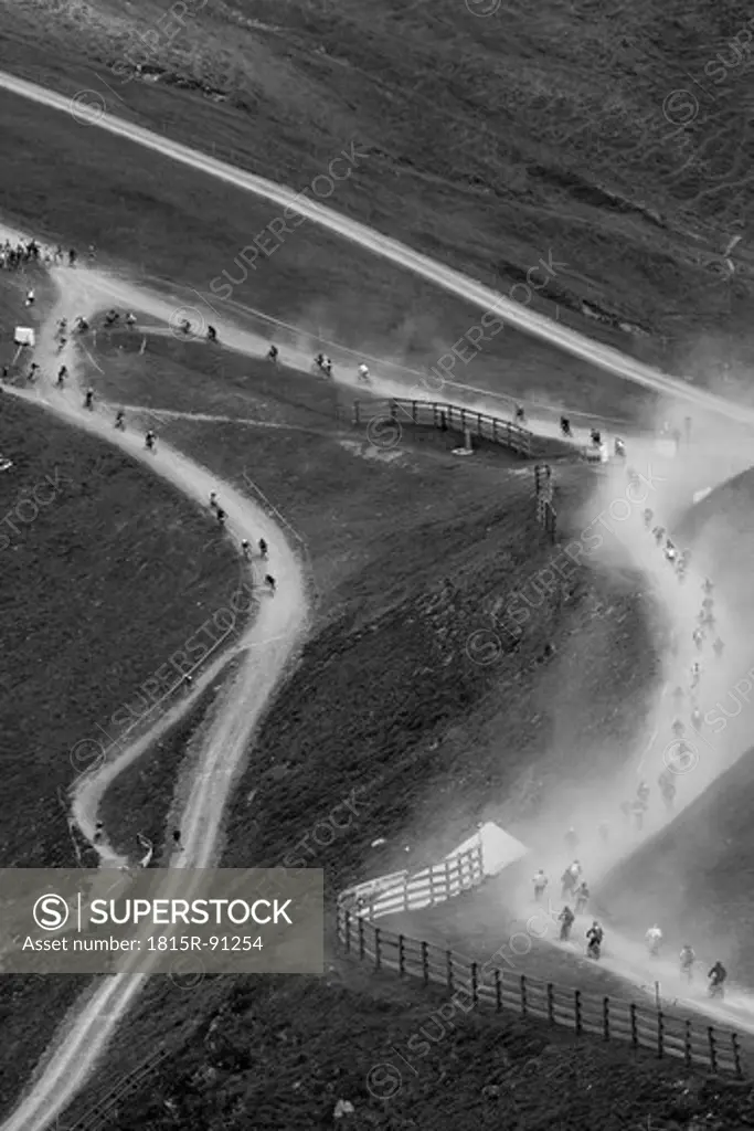 Austria, Salzburger Land, Hinterglemm, View of mountainbike downhill race on dusty gravel road