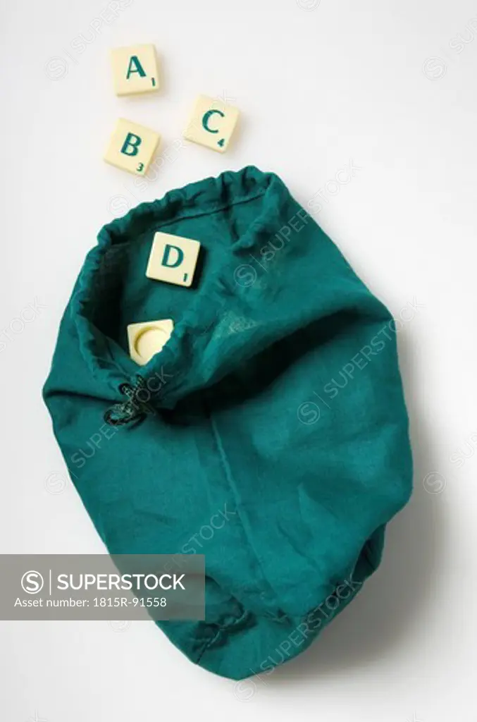 ABC letter of scrabble game with bag on white background