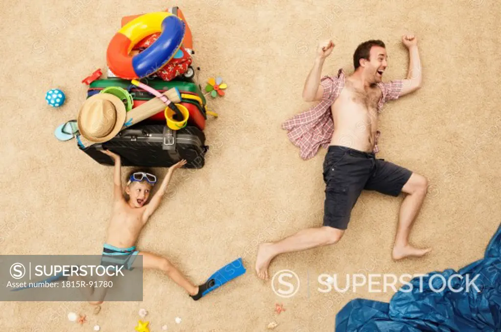 Germany, Father and son with toys and baggage at beach