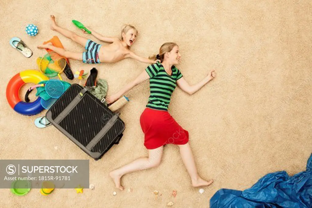 Germany, Mother and son with toys and baggage at beach