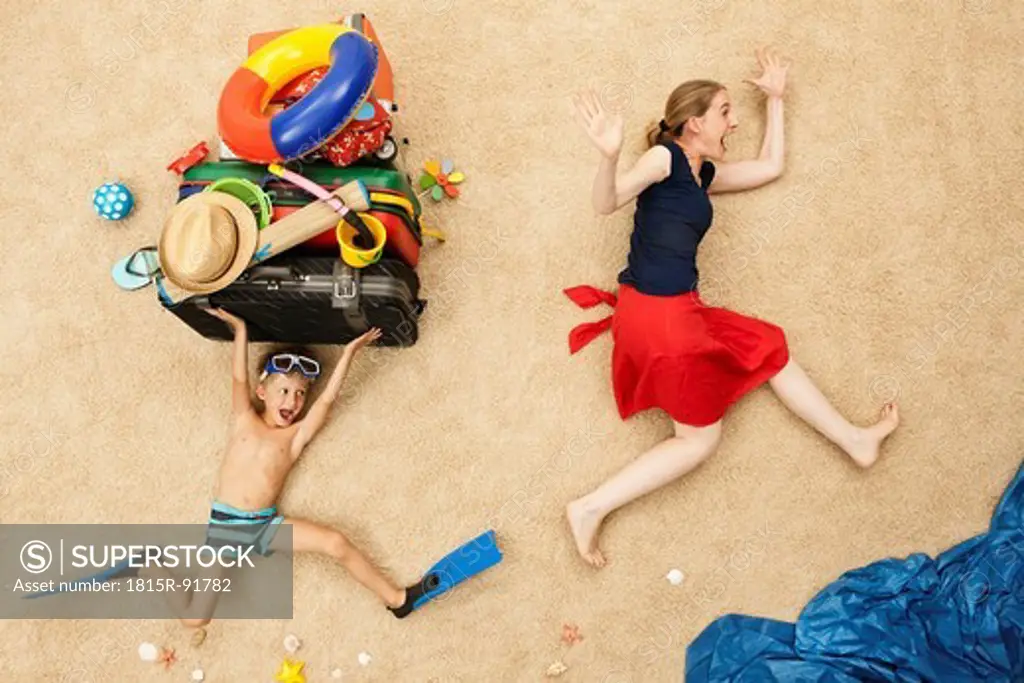 Germany, Mother and son with toys and baggage at beach