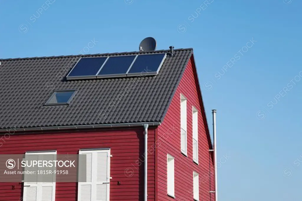 Germany, Cologne, Roof of wooden residential building with solar panels